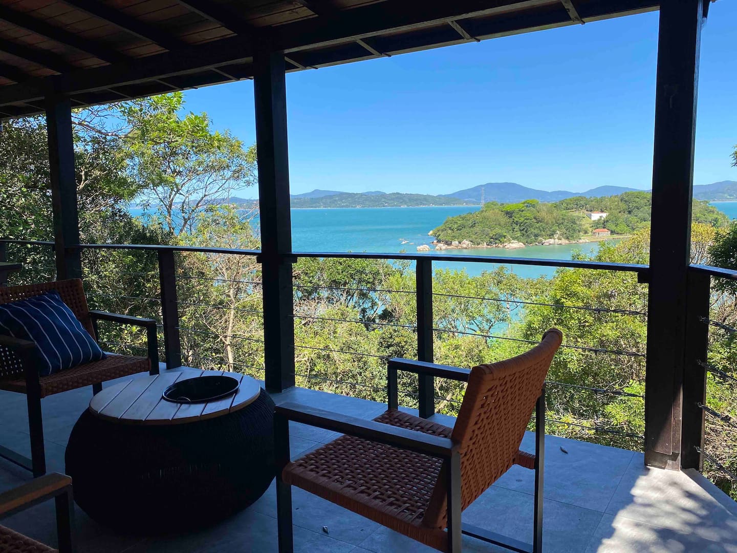 Varanda com poltronas e vista para a baía